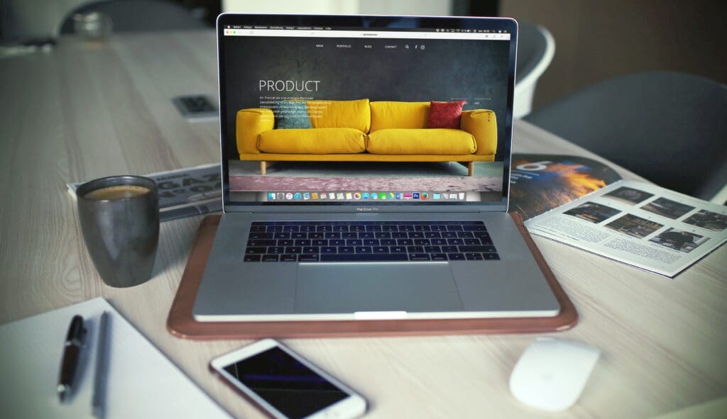 Laptop displaying product website design.