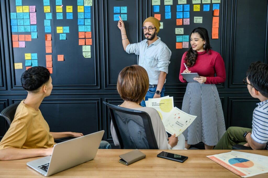 Team brainstorming with sticky notes.