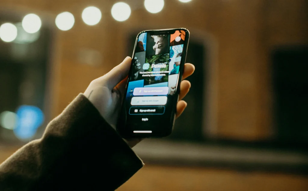 Hand holding phone with app interface