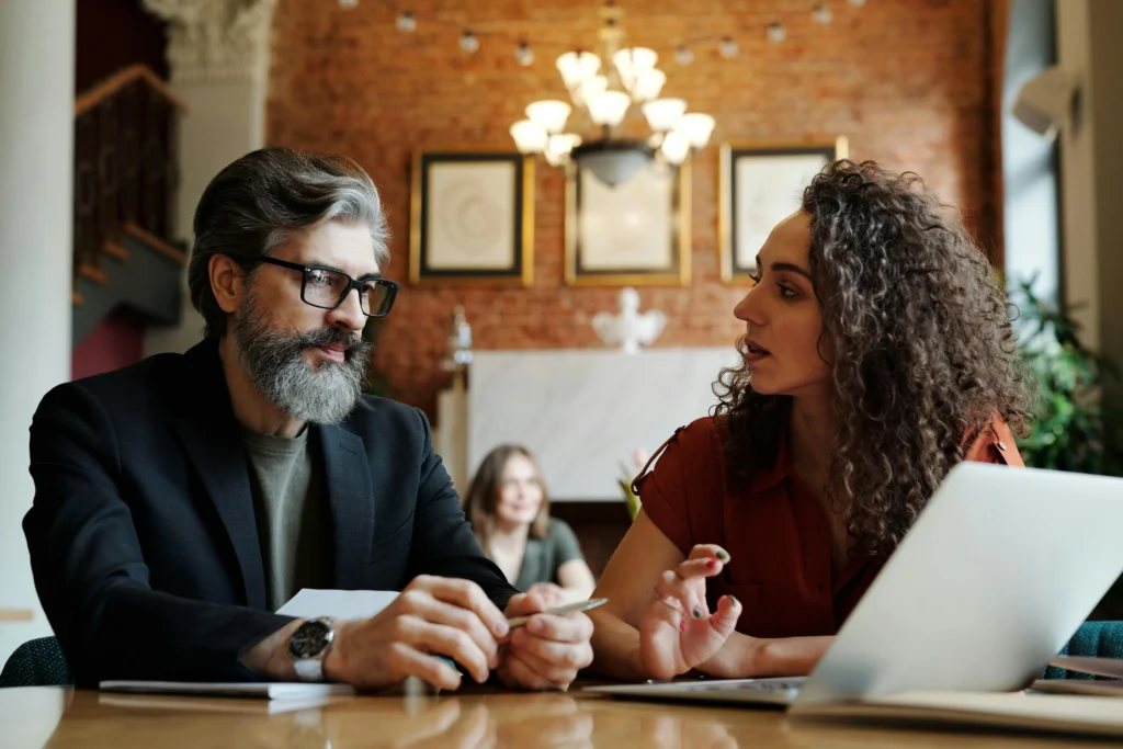 Two people discussing at a table.